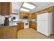 Well-lit kitchen featuring wood cabinets, a built-in microwave, and durable flooring at 14151 W Yosemite Dr, Sun City West, AZ 85375