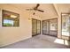 Covered patio offering a comfortable outdoor living space with a ceiling fan and natural lighting at 14151 W Yosemite Dr, Sun City West, AZ 85375