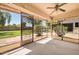 Enclosed screened porch providing an insect-free outdoor area with a view of the landscaped backyard at 14151 W Yosemite Dr, Sun City West, AZ 85375