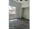 Bright bedroom featuring hardwood floors, a ceiling fan, and a window offering natural light at 1519 N Etta St, Casa Grande, AZ 85122
