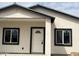 Charming home featuring a white front door, dark framed windows and a security camera at 1519 N Etta St, Casa Grande, AZ 85122