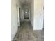 Hallway with tile flooring leading to a white front door and multiple rooms at 1519 N Etta St, Casa Grande, AZ 85122