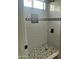 Modern shower with decorative tile, shower head, and a mosaic tile floor at 1519 N Etta St, Casa Grande, AZ 85122