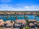Aerial view of waterfront community with a lake, houses, and palm trees on a sunny day at 1539 W Laurel Ave, Gilbert, AZ 85233