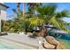 Beautiful waterfront backyard featuring boat lift, lush landscaping, and palm trees at 1539 W Laurel Ave, Gilbert, AZ 85233