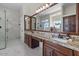 Spacious bathroom with dual sinks, granite counters, large mirror, and walk-in shower at 1539 W Laurel Ave, Gilbert, AZ 85233