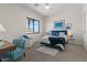 Cozy bedroom with large window, plush carpet, and comfortable seating area at 1539 W Laurel Ave, Gilbert, AZ 85233