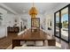 Spacious dining room with an ornate chandelier, large table, and access to the pool area at 1539 W Laurel Ave, Gilbert, AZ 85233