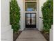 Inviting front entrance with an elegant black double door, a stone pathway, and manicured landscaping at 1539 W Laurel Ave, Gilbert, AZ 85233