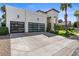 Modern white home featuring a large garage, well-manicured green lawn and desert landscaping at 1539 W Laurel Ave, Gilbert, AZ 85233
