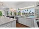 Bright kitchen features white cabinets, marble countertops, stainless steel appliances and a gorgeous view of the pool at 1539 W Laurel Ave, Gilbert, AZ 85233