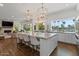 Beautiful kitchen with seating for four, statement lighting, and open to the living room, perfect for entertaining at 1539 W Laurel Ave, Gilbert, AZ 85233