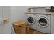 Clean laundry area with front-loading washer and dryer, plus woven storage baskets at 1539 W Laurel Ave, Gilbert, AZ 85233