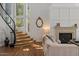 Inviting living room with a fireplace, wood floors, and adjacent stairway at 1539 W Laurel Ave, Gilbert, AZ 85233