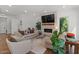 Bright living room featuring a stone fireplace, wood floors, and comfortable seating at 1539 W Laurel Ave, Gilbert, AZ 85233