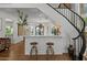 Chic living space featuring a bar, staircase, and view of the dining area at 1539 W Laurel Ave, Gilbert, AZ 85233