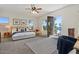Bright main bedroom featuring a king bed, ceiling fan, and access to a balcony at 1539 W Laurel Ave, Gilbert, AZ 85233