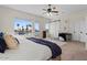 Bright main bedroom features a water view, ceiling fan, and stylish barn door at 1539 W Laurel Ave, Gilbert, AZ 85233