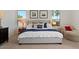 Bright primary bedroom with a bed, side tables, and lots of pillows at 1539 W Laurel Ave, Gilbert, AZ 85233