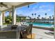 Charming patio with cozy seating, waterfront view, and access to the beautiful pool area at 1539 W Laurel Ave, Gilbert, AZ 85233