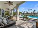 Inviting outdoor patio area with waterfront views, lounge seating, and a view of the pool at 1539 W Laurel Ave, Gilbert, AZ 85233