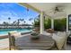 Relaxing outdoor patio with comfortable seating overlooking the serene waterfront and pool at 1539 W Laurel Ave, Gilbert, AZ 85233