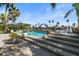 Gorgeous pool with water feature and beautiful waterfront view surrounded by lush tropical landscaping at 1539 W Laurel Ave, Gilbert, AZ 85233