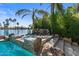 Lush tropical landscaping surrounds pool with waterfall feature, near waterfront at 1539 W Laurel Ave, Gilbert, AZ 85233