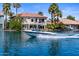 Beautiful waterfront home with boat on a pristine lake, perfect for enjoying sunny days and water activities at 1539 W Laurel Ave, Gilbert, AZ 85233