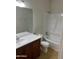 Modern bathroom featuring a vanity with dark wood cabinets, and a shower-tub combo at 15461 W Jefferson St, Goodyear, AZ 85338