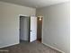 Spacious bedroom with carpeted floor, neutral walls, and access to a walk-in closet at 15461 W Jefferson St, Goodyear, AZ 85338