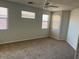 Spacious bedroom with carpeted floors and multiple windows providing natural light at 15461 W Jefferson St, Goodyear, AZ 85338