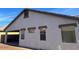 Exterior side view of home featuring a carport, well-maintained stucco, and multi-pane windows at 15461 W Jefferson St, Goodyear, AZ 85338