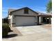 Charming single-story home featuring a two-car garage, a modern roof, and a well-maintained front yard at 15461 W Jefferson St, Goodyear, AZ 85338
