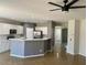 Open concept kitchen featuring white cabinets, light countertops, and stainless steel appliances at 15461 W Jefferson St, Goodyear, AZ 85338