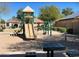 Community playground with slide, swings, and picnic tables for outdoor enjoyment at 15461 W Jefferson St, Goodyear, AZ 85338