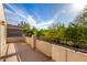 Spacious balcony with black metal railing offering views of lush landscaping and a bright, sunny sky at 1550 S Chaparral Blvd, Gilbert, AZ 85296