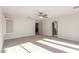 Bright bedroom with a ceiling fan, neutral carpet, and white walls, offering a serene and inviting atmosphere at 1550 S Chaparral Blvd, Gilbert, AZ 85296