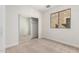 Bright bedroom with carpet, a closet with mirrored sliding doors, and a large window at 1550 S Chaparral Blvd, Gilbert, AZ 85296