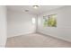 Bright bedroom boasts natural light through two windows and has neutral carpet at 1550 S Chaparral Blvd, Gilbert, AZ 85296