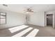 Bright, spacious bedroom with a ceiling fan, window shutters, and neutral carpet flooring at 1550 S Chaparral Blvd, Gilbert, AZ 85296