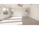 Bright bedroom featuring a ceiling fan, and natural light from windows with views of the neighborhood at 1550 S Chaparral Blvd, Gilbert, AZ 85296
