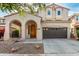 Charming two-story home with a spacious two-car garage and an arched entryway, creating a welcoming curb appeal at 1550 S Chaparral Blvd, Gilbert, AZ 85296
