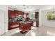 Modern kitchen with dark wood cabinets, stainless steel appliances, and center island with granite countertop at 1550 S Chaparral Blvd, Gilbert, AZ 85296