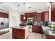 Well-appointed kitchen with stainless steel appliances, custom cabinets, and functional center island, ready for chef at 1550 S Chaparral Blvd, Gilbert, AZ 85296