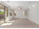 Spacious living room with tile flooring, ceiling fan, and sliding glass doors to the outside patio at 1550 S Chaparral Blvd, Gilbert, AZ 85296