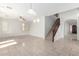 Open-concept living space with elegant tile flooring and a staircase, perfect for modern living and entertaining guests at 1550 S Chaparral Blvd, Gilbert, AZ 85296