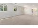 Spacious living room with neutral-toned walls, carpeted floors, and windows adorned with white shutters at 1550 S Chaparral Blvd, Gilbert, AZ 85296