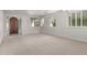 Inviting living room with plush carpeting and large windows, offering a cozy and well-lit area for relaxation at 1550 S Chaparral Blvd, Gilbert, AZ 85296