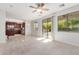 Bright living room with an adjacent kitchen and large windows providing ample natural light, creating a warm and inviting space at 1550 S Chaparral Blvd, Gilbert, AZ 85296